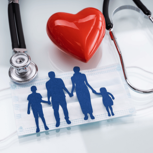 A stethoscope, heart and family on top of the table.